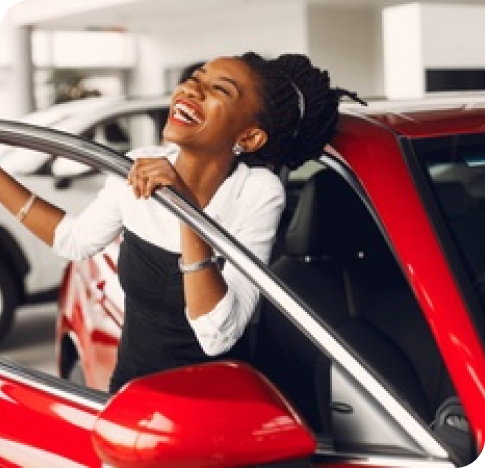 Black woman smiling with her car